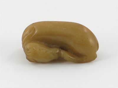 Appraisal: A small Chinese yellowy-brown jade carving of a recumbent goat