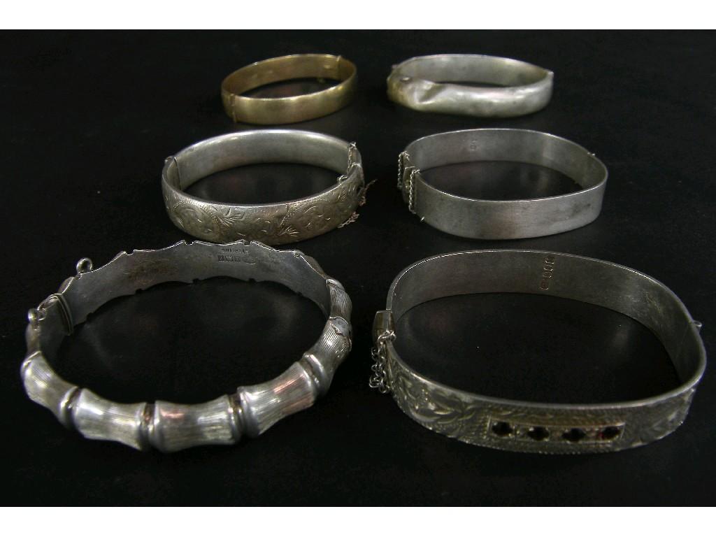 Appraisal: s bangle engraved with acanthus and inset with four red