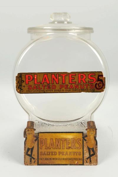 Appraisal: Planters Peanuts Jar With Tin Sign Stand This jar has