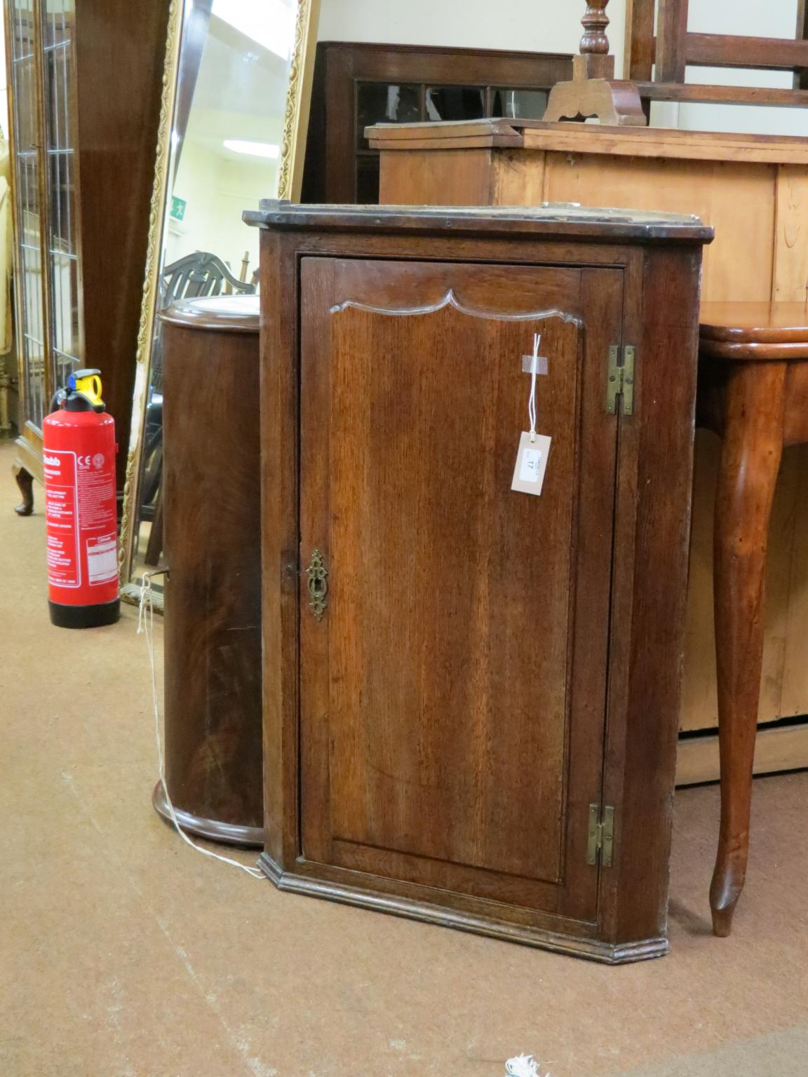 Appraisal: A George II provincial oak corner cupboard single door with