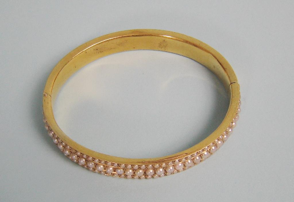 Appraisal: A Continental Pearl hinged Bangle the front millegrain-set three rows