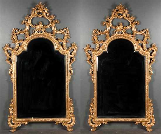 Appraisal: Pair of rococo style giltwood beveled glass mirrors scroll and