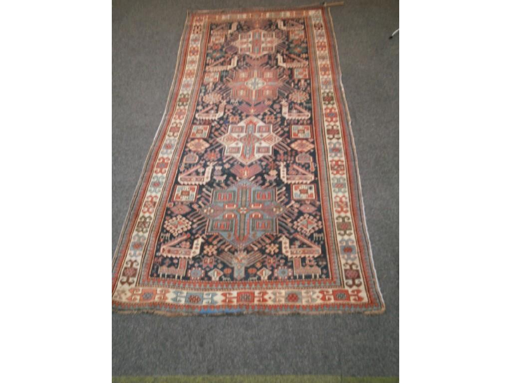 Appraisal: A Tekke design rug with blue ground centre field and