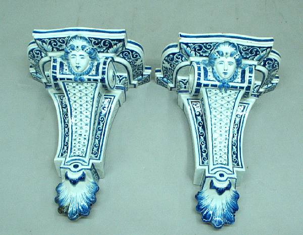 Appraisal: A pair of French R gence style faience wall brackets