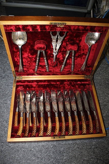 Appraisal: A SET OF TWELVE SILVER PLATED FRUIT KNIVES and forks