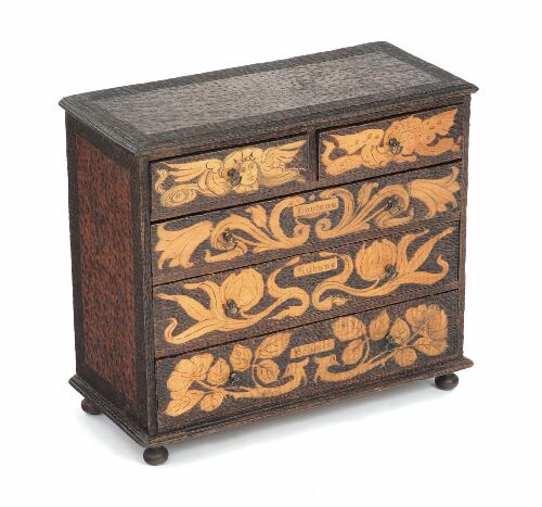 Appraisal: A miniature pokerwork chest of drawers with two short over