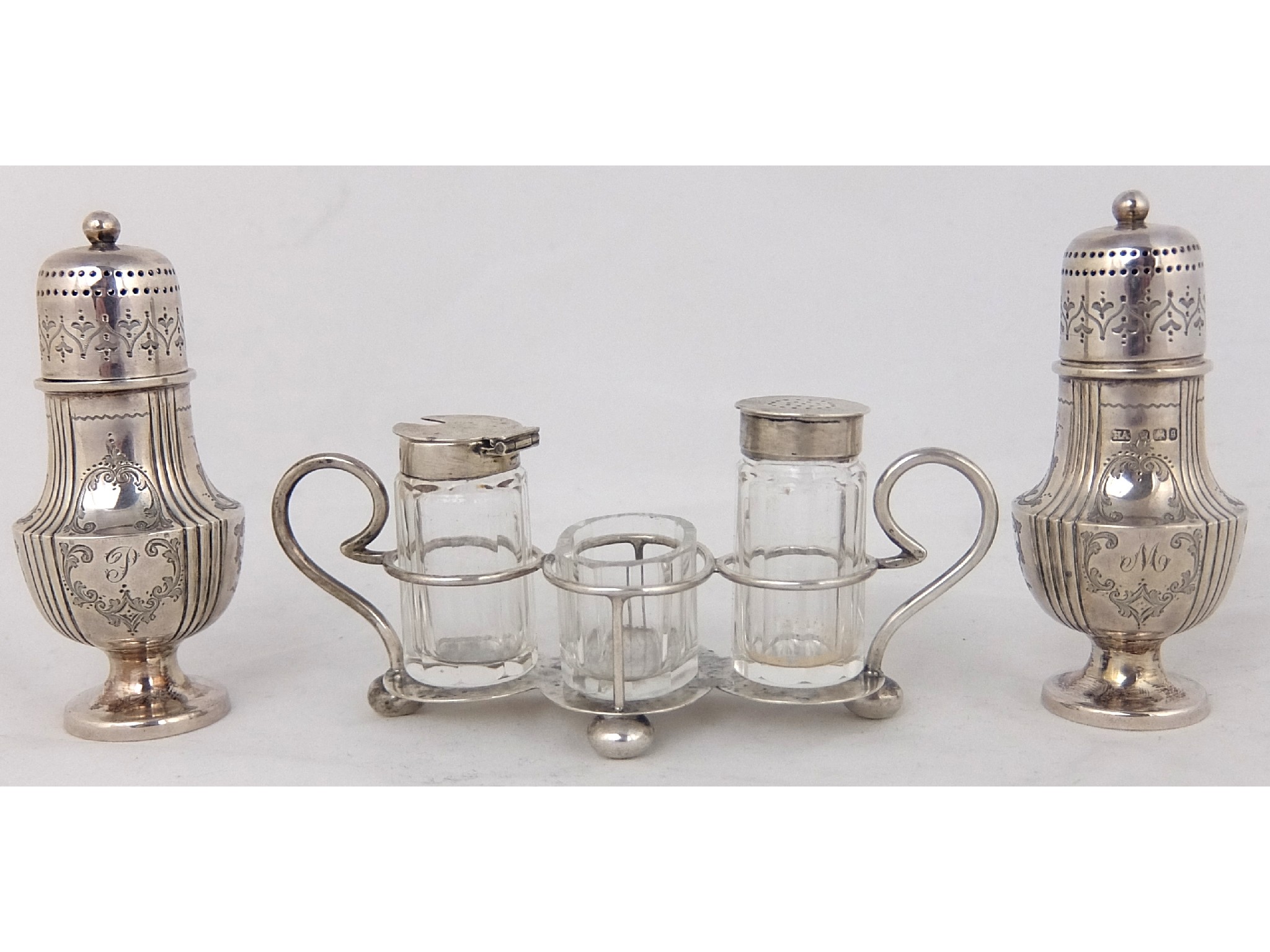 Appraisal: A pair of silver pepperettesby Aitkin Brothers Sheffield of baluster