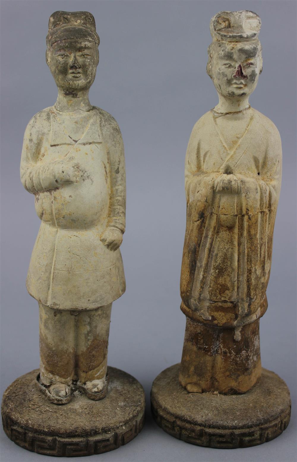 Appraisal: PAIR OF POTTERY MALE FIGURES both figures in long robes