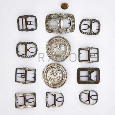 Appraisal: THIRTEEN BUCKLES OR BUTTONS Includes silver iron brass bronze th-