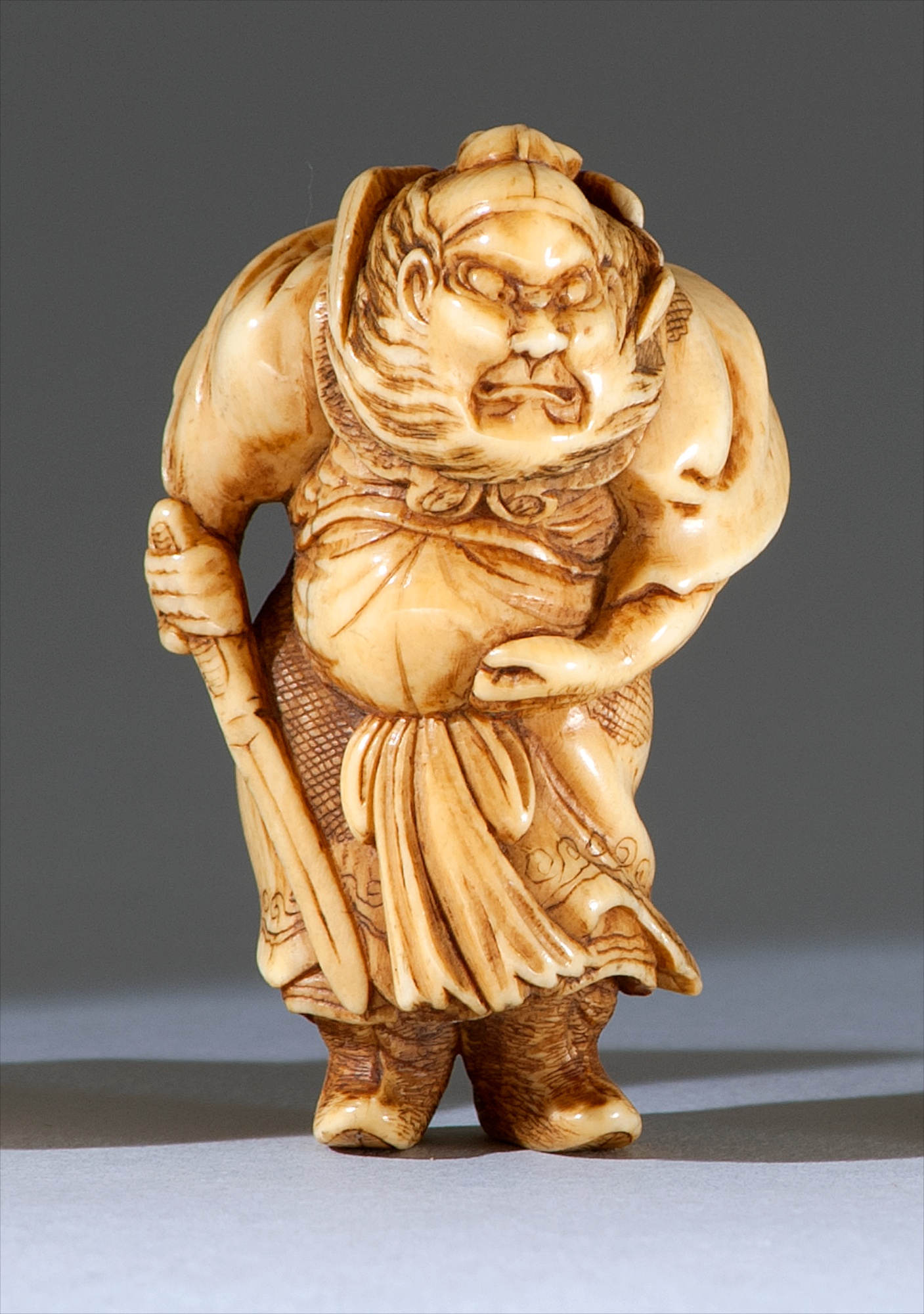 Appraisal: IVORY NETSUKE th CenturyIn the form of Shoki standing with