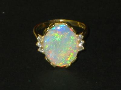 Appraisal: AN OPAL AND DIAMOND RING the cabochon oval flanked to