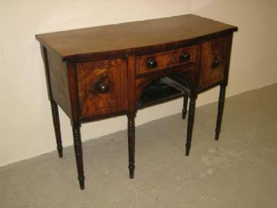 Appraisal: A REGENCY MAHOGANY SIDEBOARD of bowed form with ebony stringing