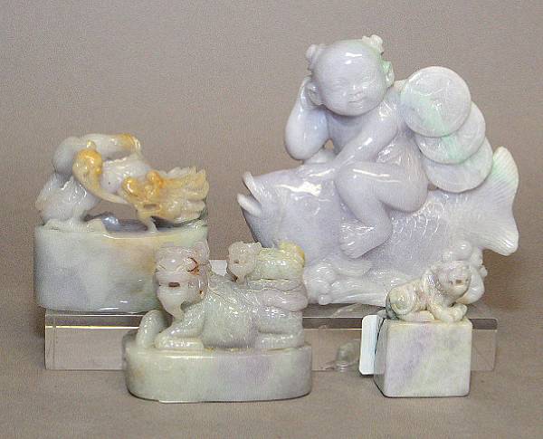 Appraisal: Four jadeite carvings Including a boy riding a carp two