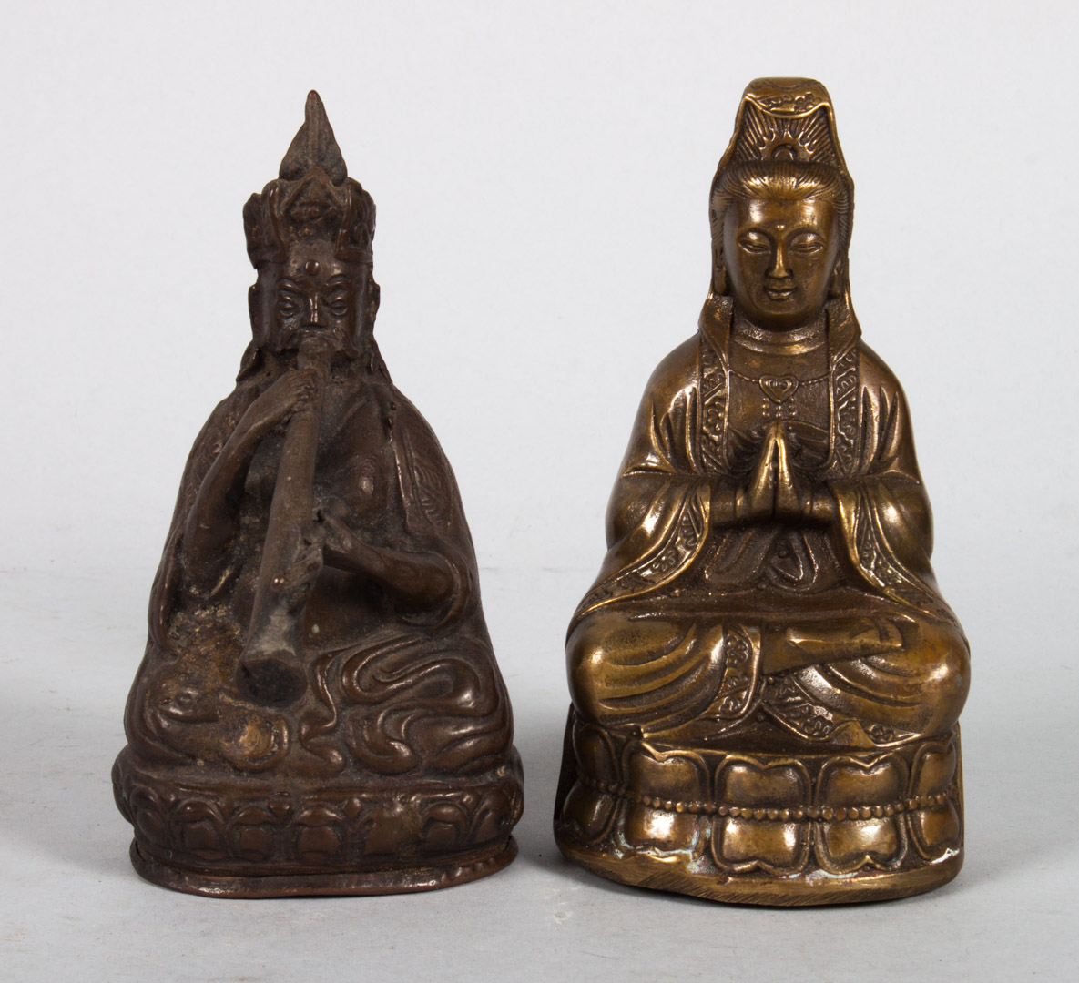 Appraisal: Two orientalia metal figures Chinese brass seated bodhisattva in H