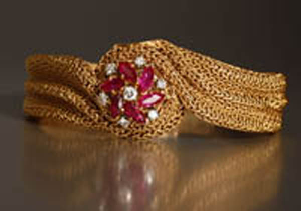 Appraisal: A ruby and diamond covered watch A ruby and diamond