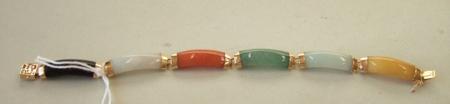 Appraisal: An Oriental gold mounted vary coloured jade bracelet designed as