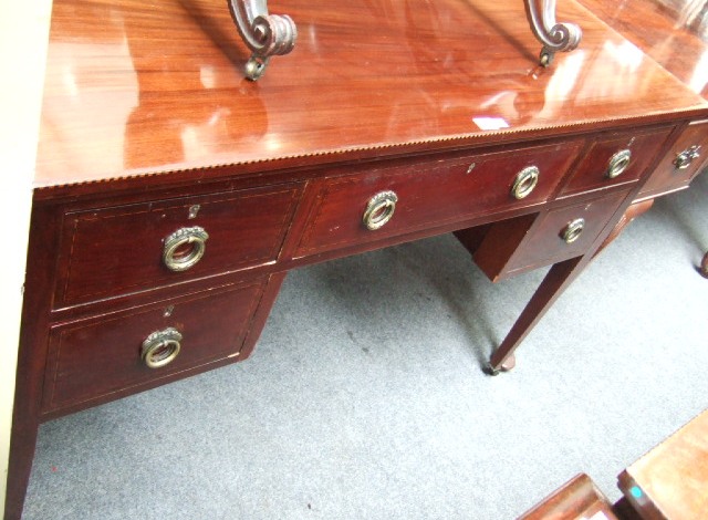 Appraisal: An Edwardian inlaid mahogany dressing table with an arrangement of