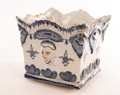 Appraisal: A Delft square planter with moulded mask heads to the