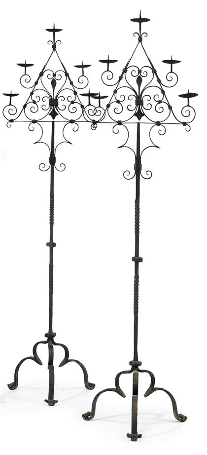 Appraisal: A pair of wrought iron standing candelabrain the manner of