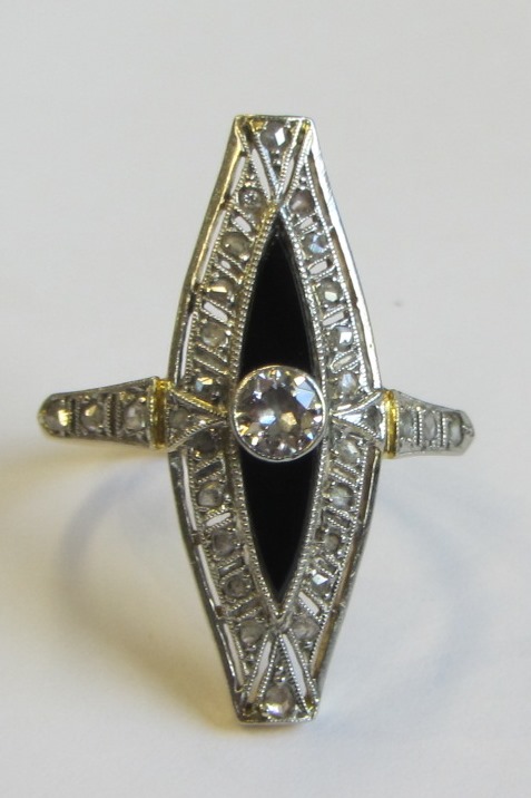 Appraisal: A gold black onyx and diamond set ring in a