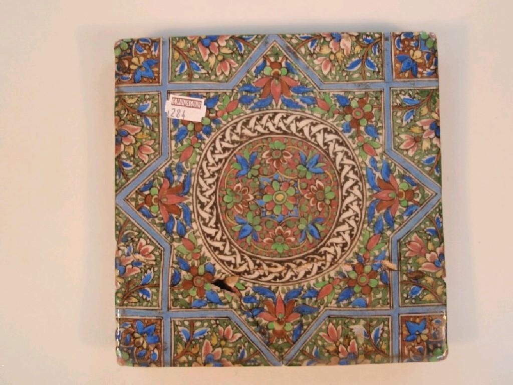 Appraisal: An Iznik tile painted with flowers and geometric panel cm