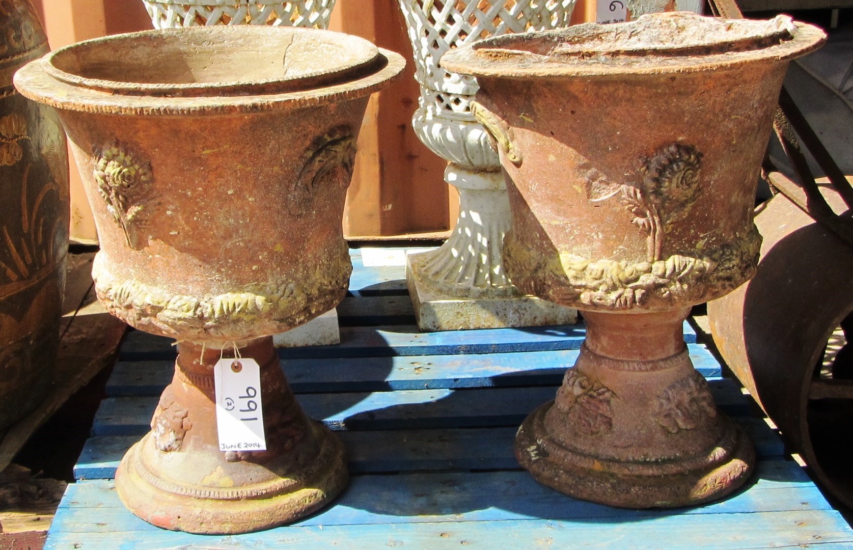 Appraisal: A pair of terracotta baluster garden urns with moulded swag