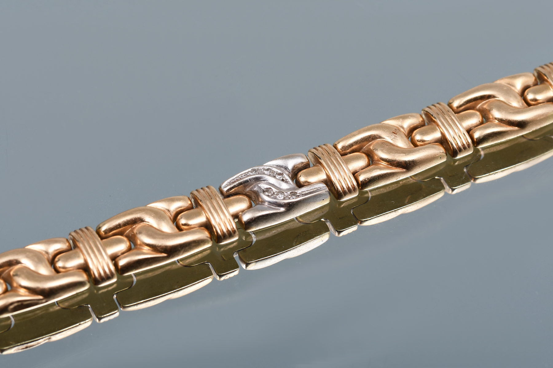 Appraisal: K DIAMOND BRACELET K two-tone gold bracelet contains round single-cut