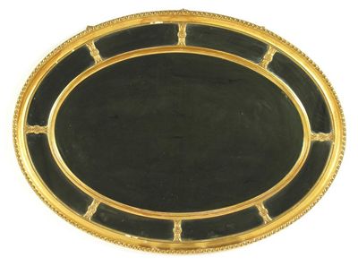 Appraisal: An Adam style giltwood and gesso oval wall mirror with