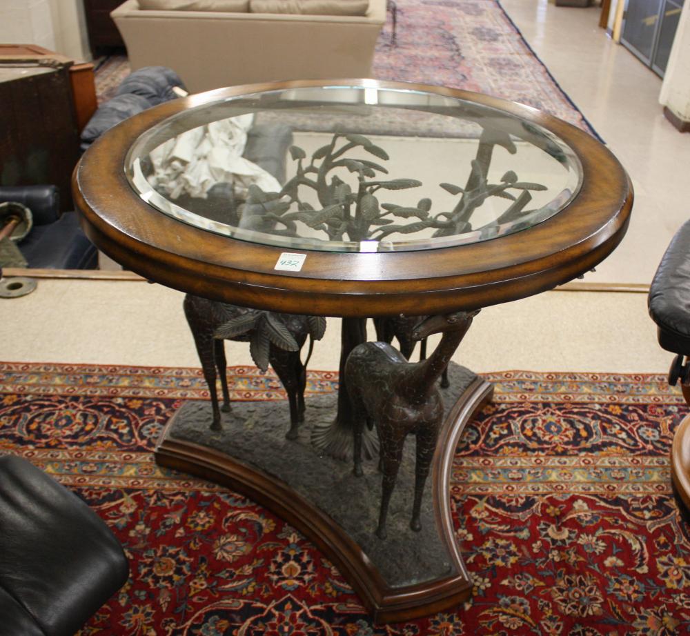 Appraisal: ROUND GLASS-TOP BRONZE TREE AND GIRAFFE CENTER TABLE the glass