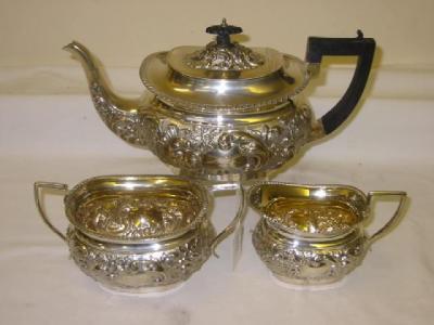 Appraisal: AN EDWARDIAN MATCHED THREE PIECE TEA SET of rounded oblong