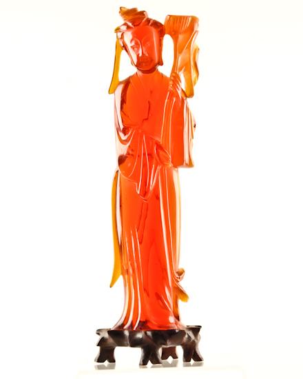 Appraisal: A Translucent Red Figure of a Quan Yin possibly amber