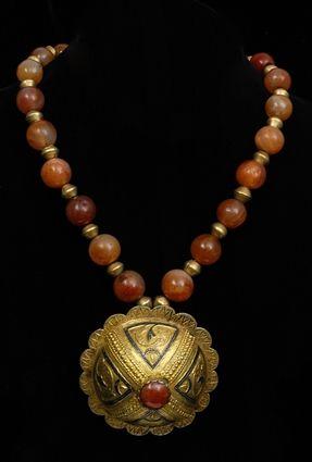 Appraisal: ISLAMIC GILT-METAL PENDANT ON AGATE AND GOLD BEAD NECKLACE in