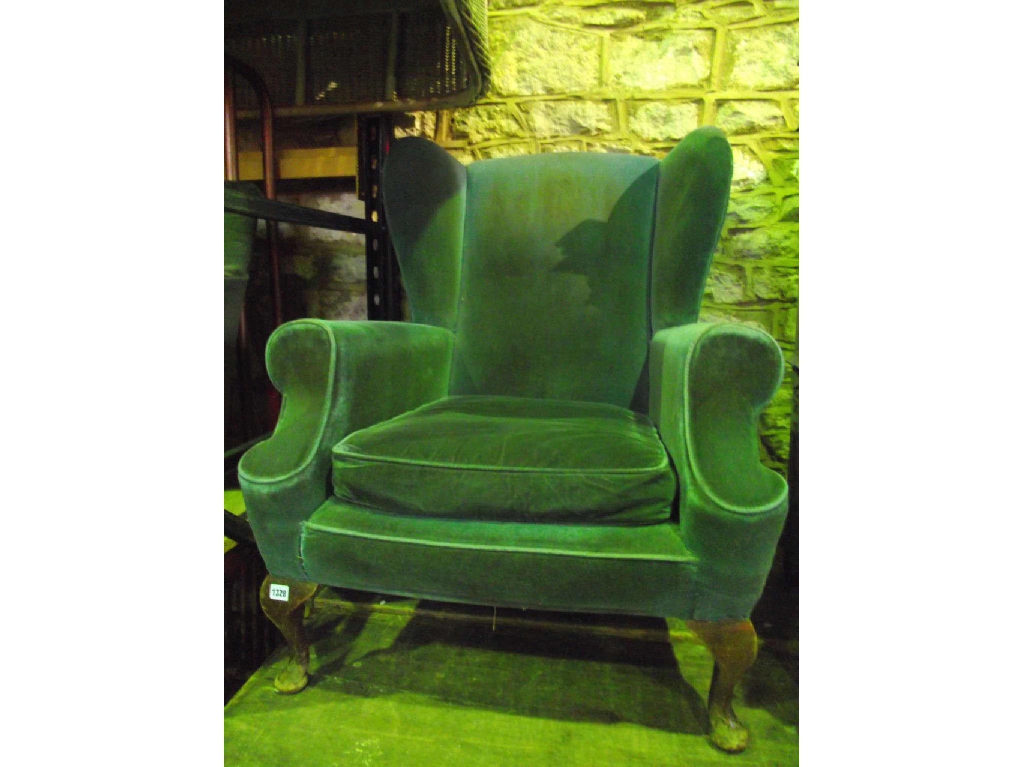 Appraisal: A Georgian style wing armchair with shaped outline and blue