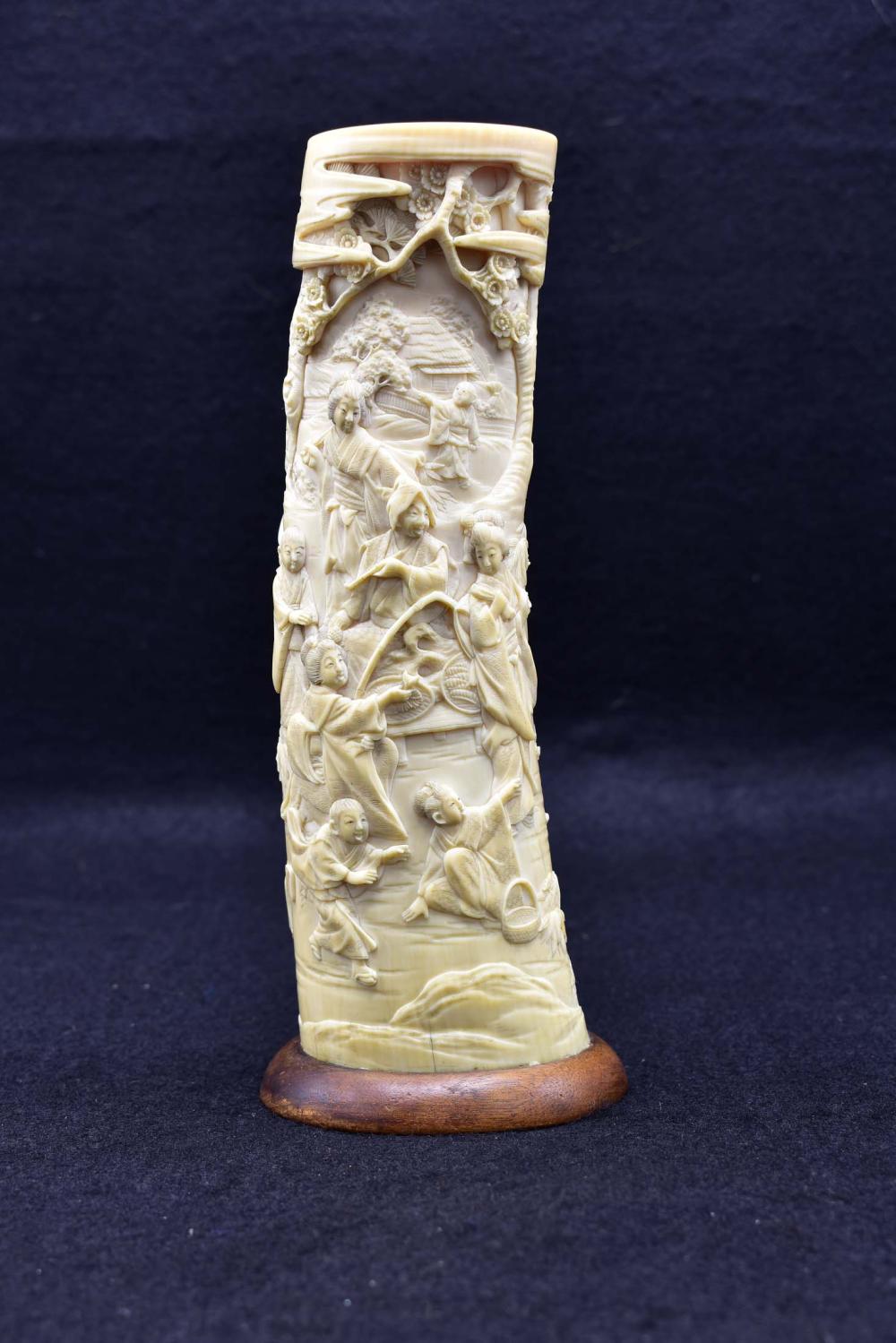 Appraisal: JAPANESE CARVED TUSK VASECirca Decorated with multiple figures in a