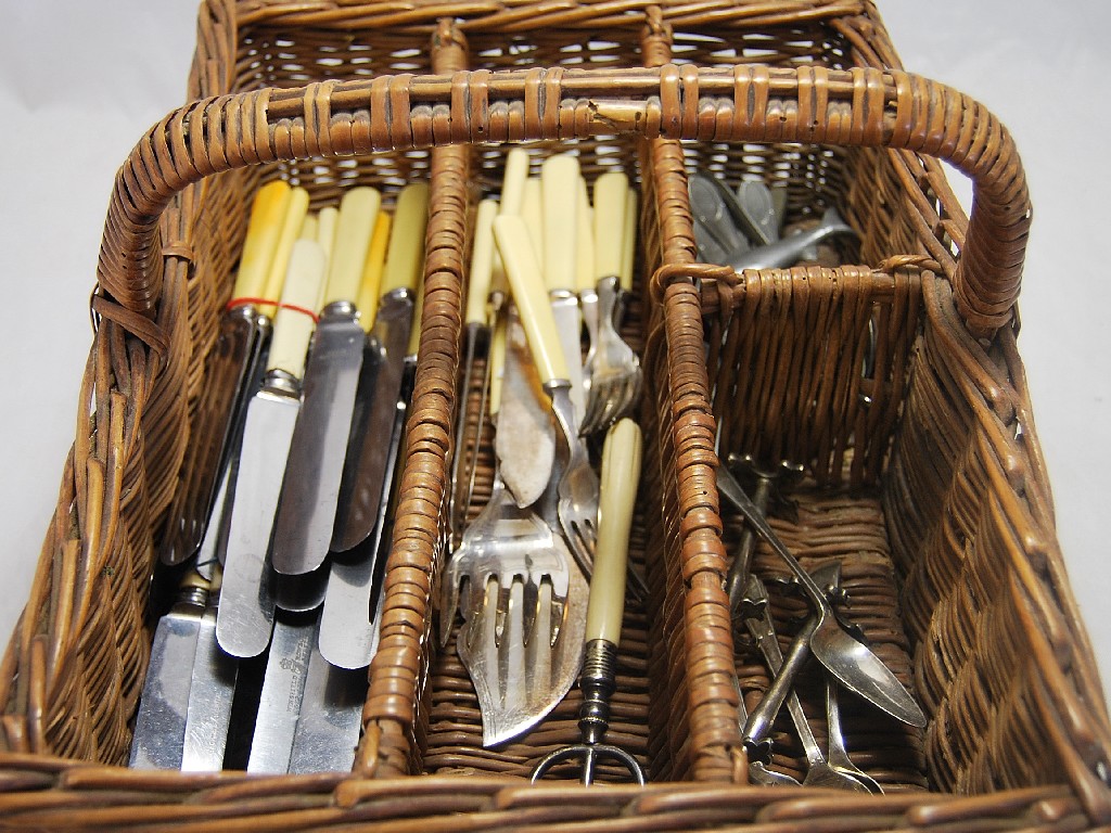 Appraisal: Quantity of steel backed knives and flatware in wicker cutlery