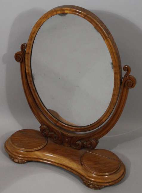 Appraisal: A Victorian mahogany table mirror with oval glass flanked by