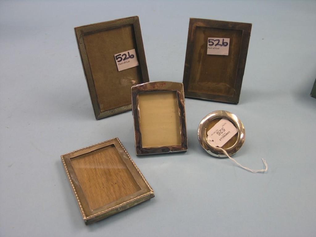 Appraisal: Four silver photograph frames rectangular-shape and a small circular silver