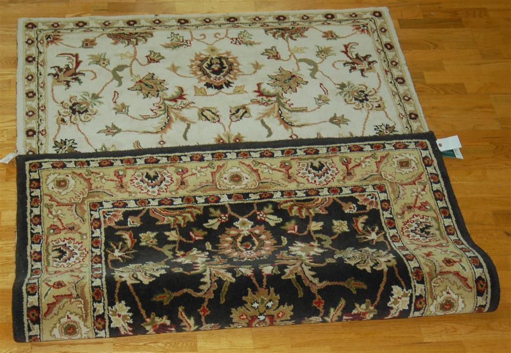 Appraisal: WHITAKER REVERSIBLE WOOL RUG having a leaf and vine design