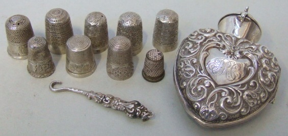 Appraisal: A collection of nine various thimbles a silver heart shaped