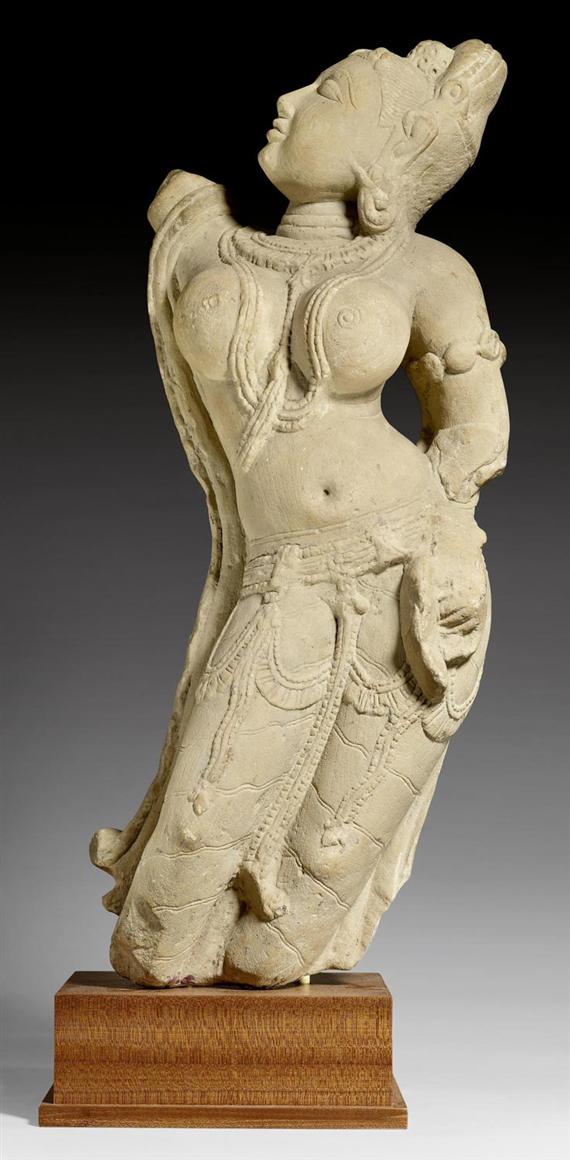 Appraisal: A BUFF SANDSTONE FIGURE OF A YAKSHI TURNING HER HEAD