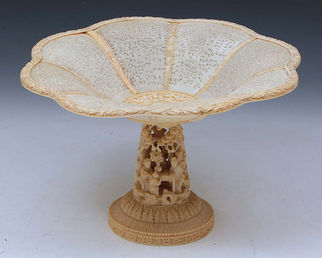 Appraisal: A CHINESE CANTON IVORY TAZZA with intricately carved panel sides