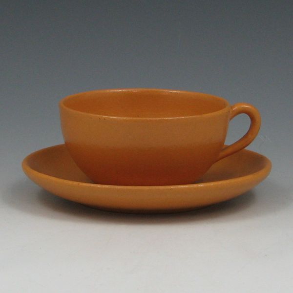 Appraisal: Paul Revere Pottery cup and saucer in mustard yellow semi-gloss