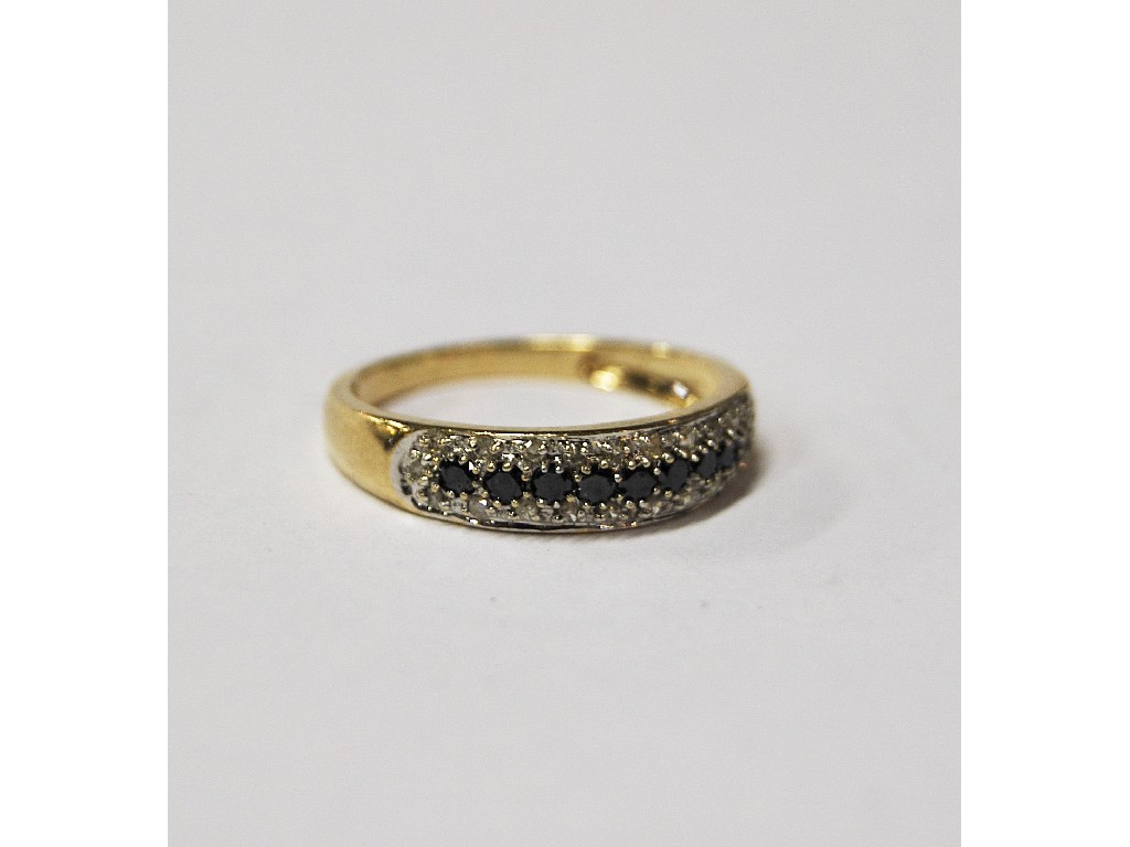 Appraisal: Diamond and black gemstone grain set half eternity ring