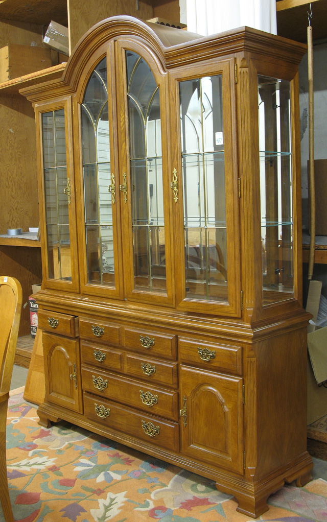 Appraisal: CONTEMPORARY OAK AND BEVELED GLASS CHINA CABINET ON BUFFET Chippendale