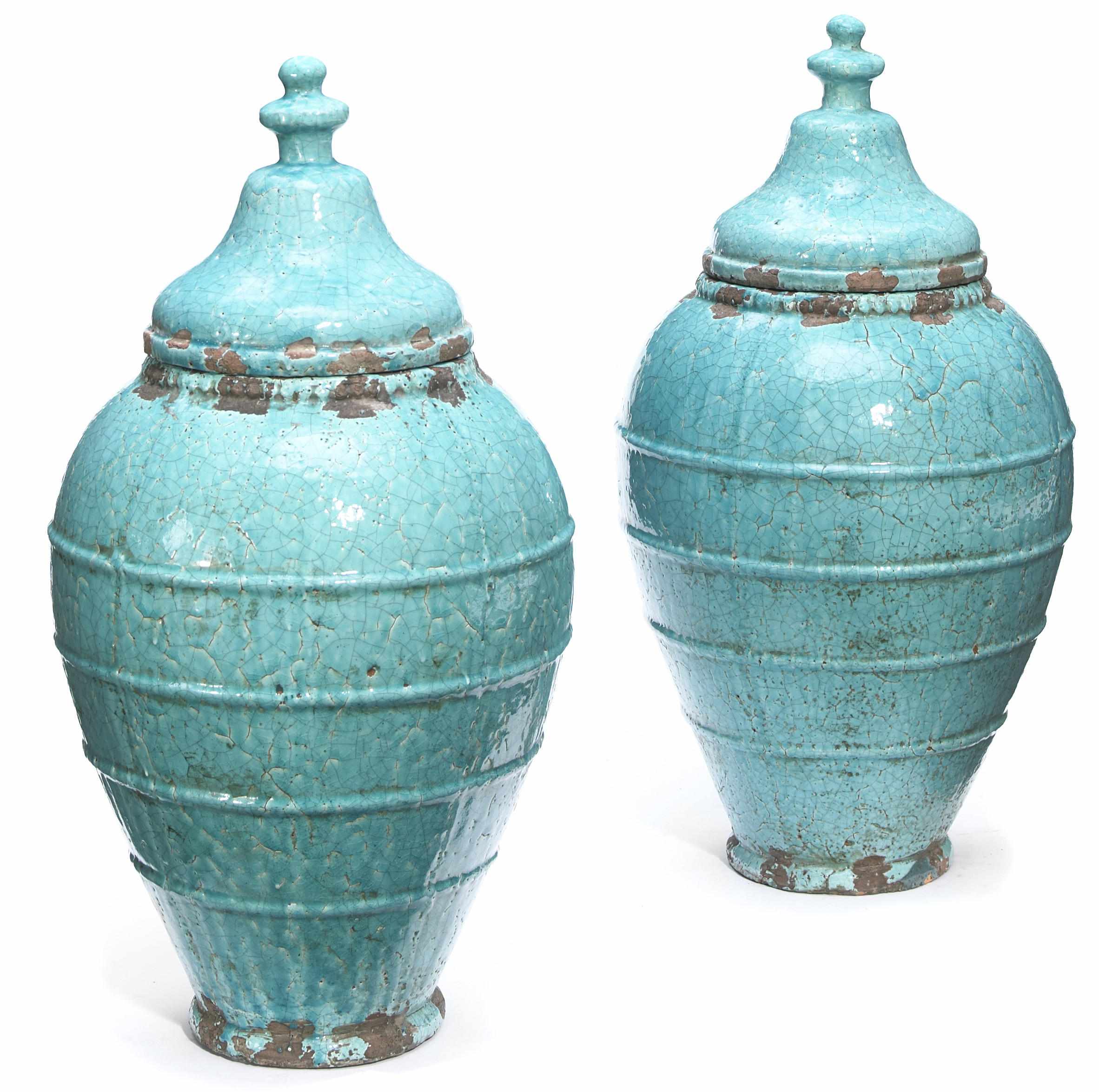 Appraisal: A pair of glazed earthenware covered vases height in cm