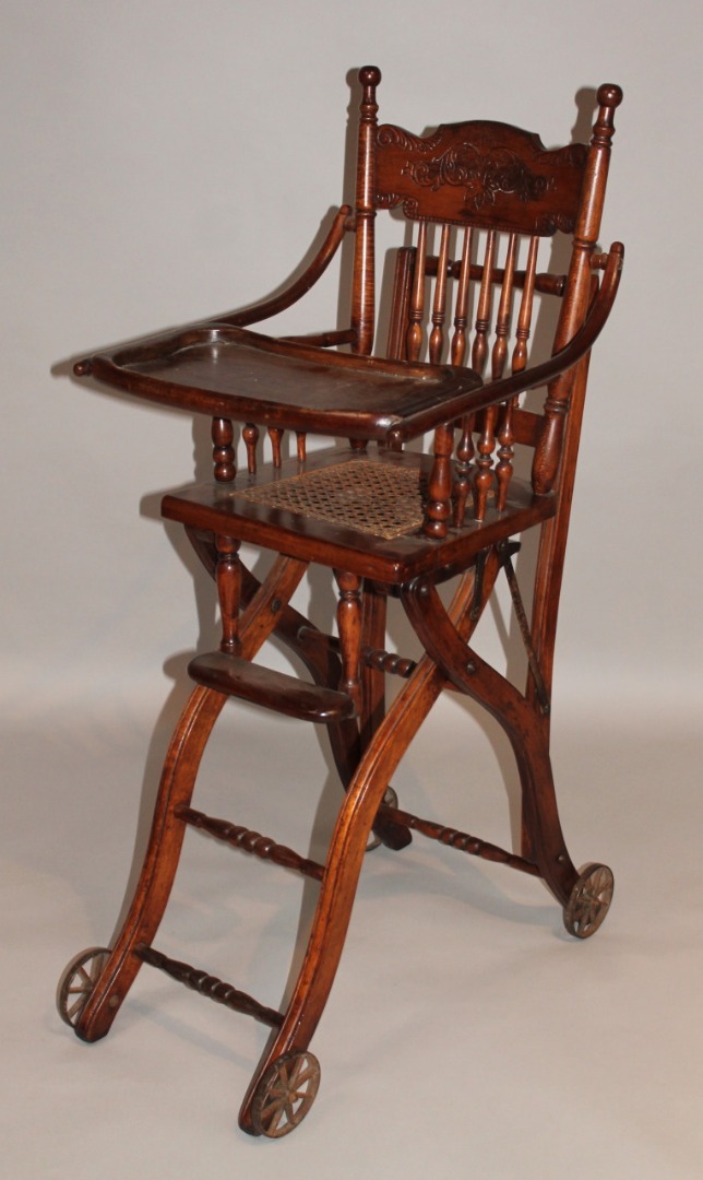 Appraisal: An early thC beech child's highchair with a carved scroll