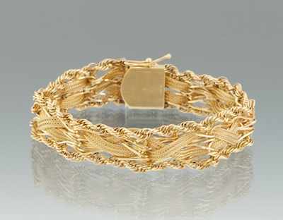 Appraisal: A Ladies' Gold Bracelet k yellow gold strap bracelet with