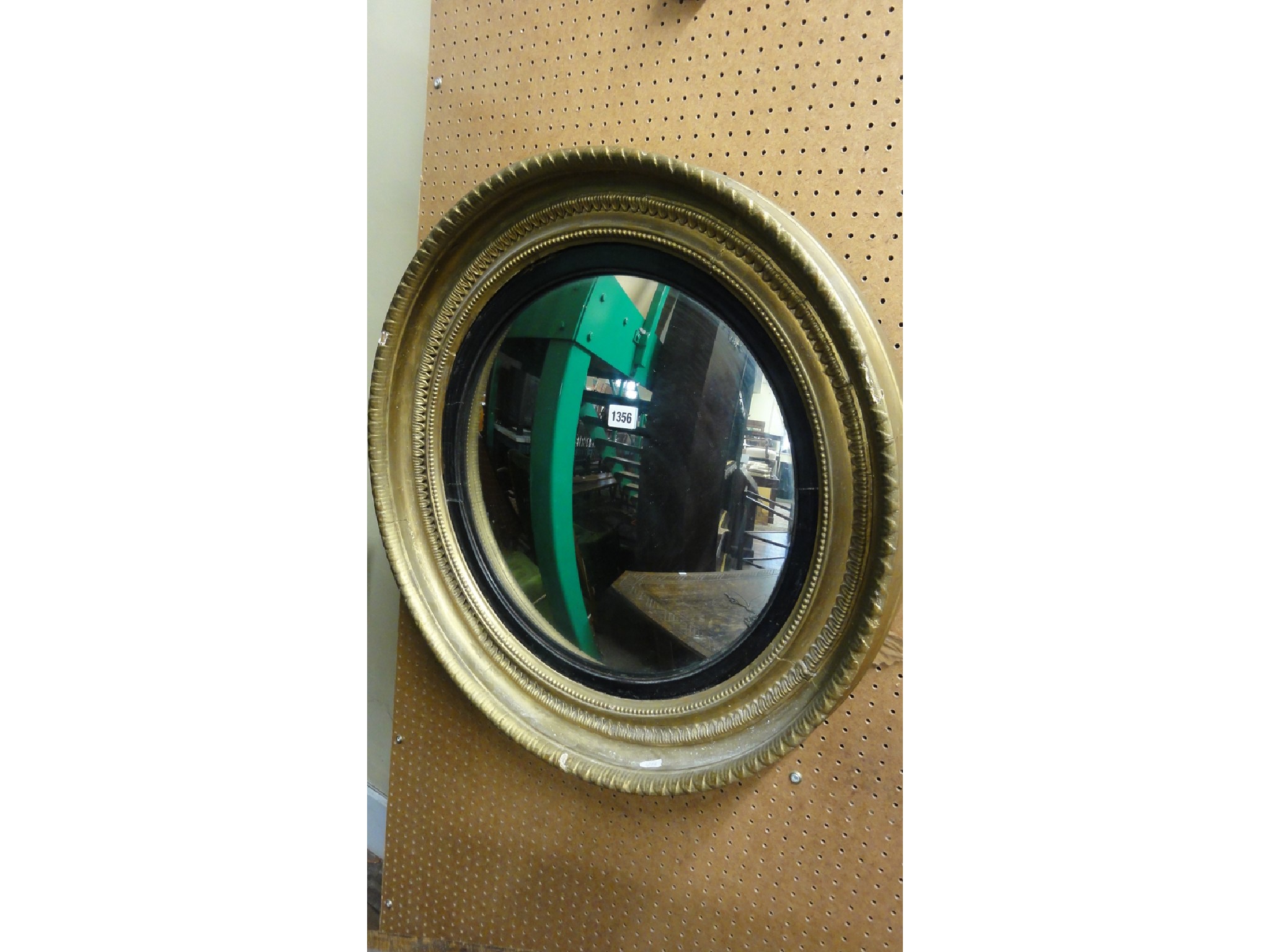 Appraisal: A th century convex wall mirror with ebonised slip and