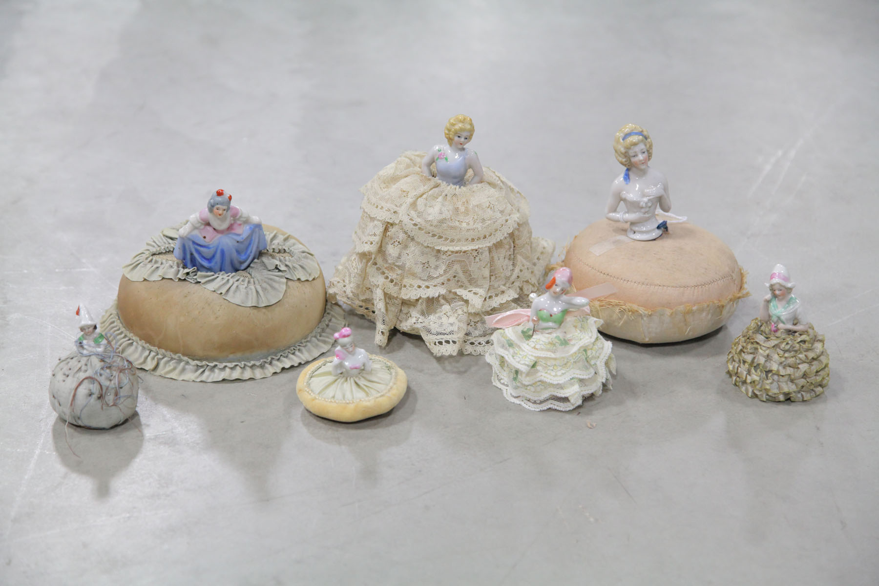 Appraisal: SEVEN DOLL PIN CUSHIONS Germany mid to late th century