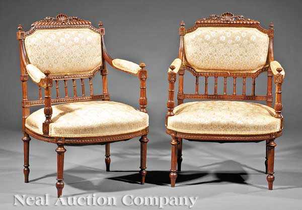 Appraisal: A Pair of French Carved Walnut Fauteuils shell and floral